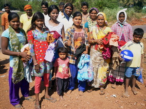 A group of roadworkers and their children receiving gifts