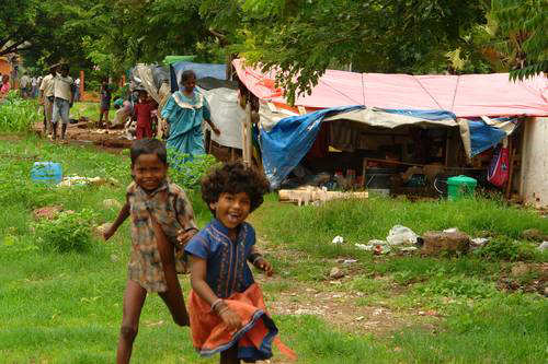 A coupe of Slum Kids Running To Us during the monsoon
