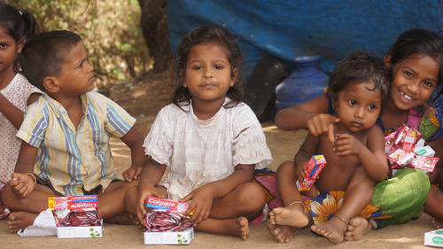 Children sat in a row waiting for Donations
