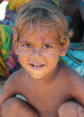 Young Boy sleeping on the path continues to Smile