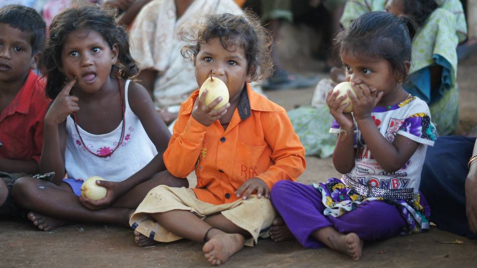 Children Sat Eating Large Sweet Pears