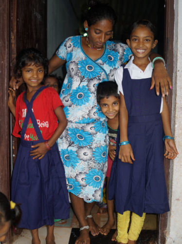 Three new children waiting for their remaining school uniforms