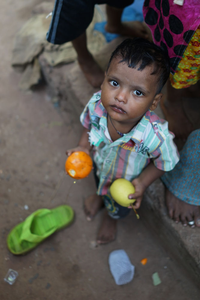 Boy Holding Fruit And Looking Up