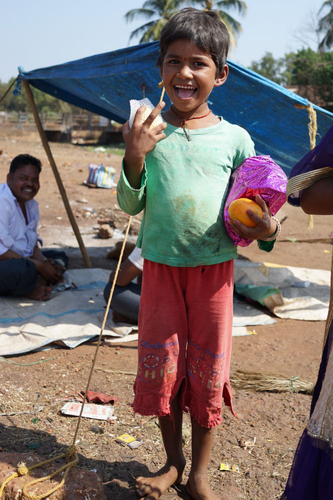 Boy Holding Presents In Slum
