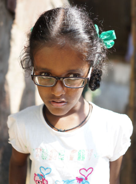 Shiny new glasses to help her see.