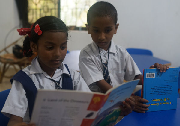 Children reading books at Goa Outreach