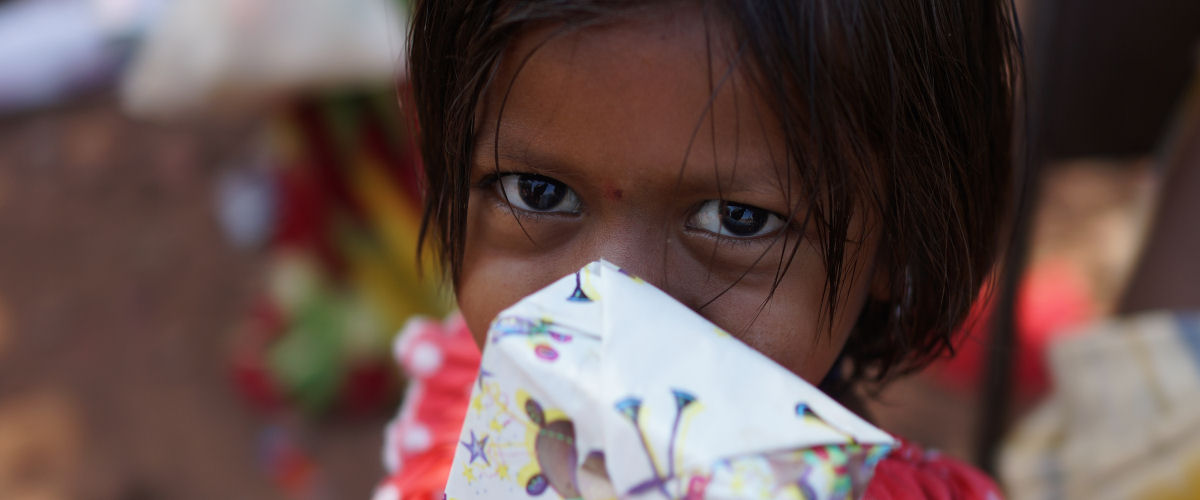 Stunning Eyes glympses over a wrapped Christmas present