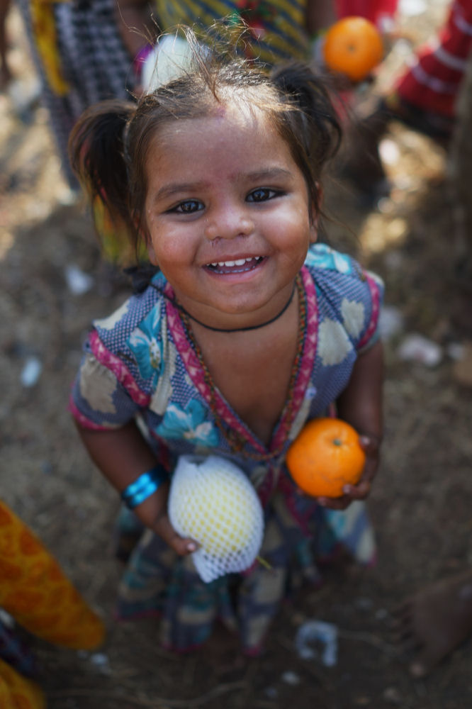 A Young Child Holding Donated Fruit