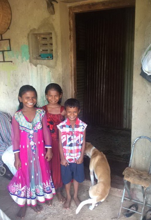 A couple of the children near the door to thier new home