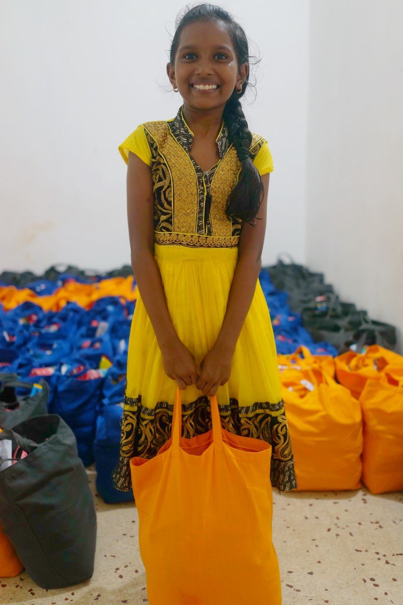 Girl Infront Of 125 Diwali Bags