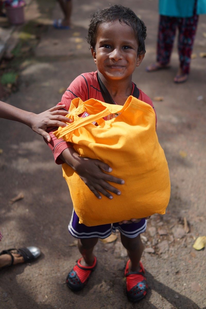 Young Boy Holding His Large Bag