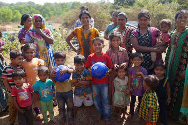 A ouple of footballs being given out to road working children