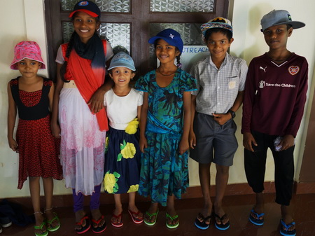 A few of the children with their caps and flipflops