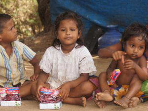 Children sat in a row waiting for Donations