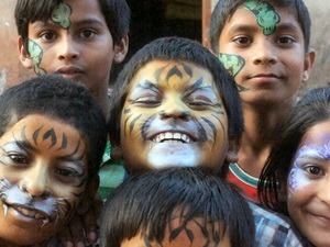 A selection of children with their faces painted2015/03-Naomi-Painting-Faces.jpg|Naomi transforming one of the children into a tiger