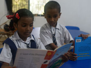 Children reading books at Goa Outreach